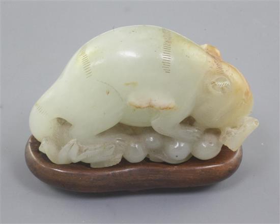 A Chinese pale celadon and russet jade figure of a tree shrew or squirrel, 18th / 19th century, 6.6cm, tiny chips, later wood stand